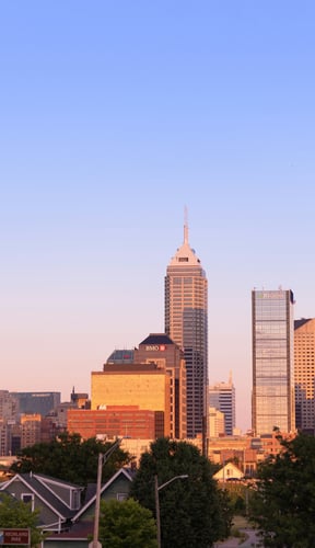 Indianapolis skyline at sunrise with warm golden light